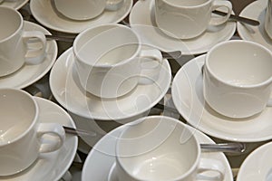 Empty cups and saucers with teaspoons.