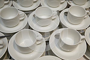 Empty cups and saucers with teaspoons.