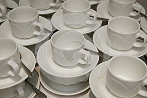 Empty cups and saucers with teaspoons.