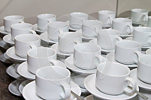 Empty cups and saucers with teaspoons.