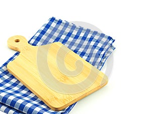 Empty cutting board on blue and white checkered fabric or napkin isolated on white background.