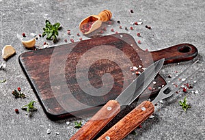 Empty cutting board, fork, knife and spices