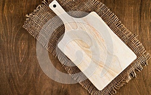 An empty cutting board on an old wooden table. Rustic, retro style