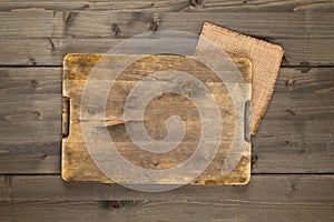 Empty cutting board on rustic brown wooden table background top view from above