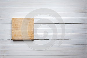 Empty cutting board on vintage white wooden board food background concept