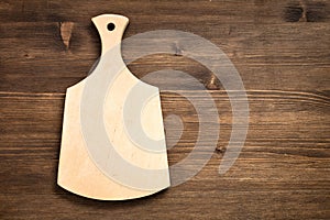 Empty cutting board on a wooden background
