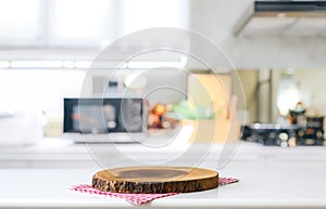 Empty cutting board on a wooden table and blurred kitchen background