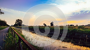 Empty cycling path along the Naviglio Pavese, canal at sunset. The canal stretches for 30km from Pavia to Milan in Lombardy, north