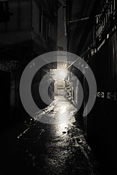 Empty and dangerous looking urban back-alley at night time in suburbs Hanoi