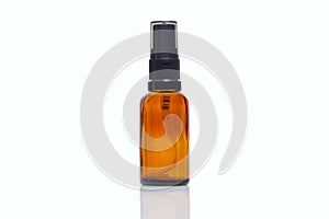 Empty dark glass spray bottle. Perfumes and essential oils. Close-up. Isolated on a white background. Space for text