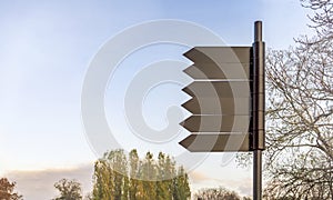 Empty dark metal sign post in nature park