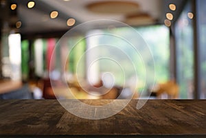 Empty dark wooden table in front of abstract blurred background