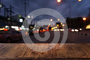 Empty dark wooden table in front of abstract blurred bokeh background of restaurant.