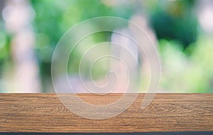 Empty dark wooden table in front of abstract blurred bokeh background of restaurant . can be used for display or montage your