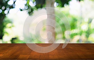 Empty dark wooden table in front of abstract blurred bokeh background of restaurant . can be used for display or montage your