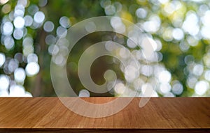 Empty dark wooden table in front of abstract blurred bokeh background of restaurant . can be used for display or montage your