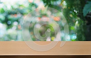 Empty dark wooden table in front of abstract blurred bokeh background of restaurant . can be used for display or montage your