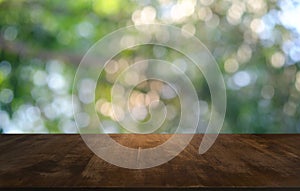 Empty dark wooden table in front of abstract blurred bokeh background of restaurant . can be used for display or montage your