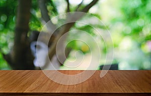 Empty dark wooden table in front of abstract blurred bokeh background of restaurant . can be used for display or montage your