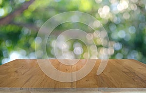 Empty dark wooden table in front of abstract blurred bokeh background of restaurant . can be used for display or montage your