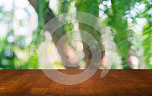 Empty dark wooden table in front of abstract blurred bokeh background of restaurant . can be used for display or montage your