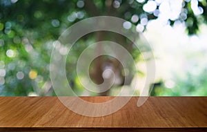 Empty dark wooden table in front of abstract blurred bokeh background of restaurant . can be used for display or montage your