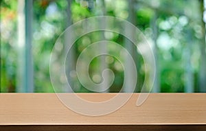 Empty dark wooden table in front of abstract blurred bokeh background of restaurant . can be used for display or montage your