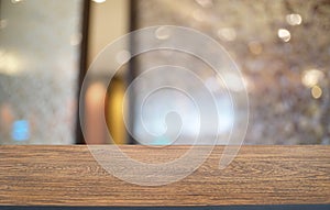 Empty dark wooden table in front of abstract blurred bokeh background of restaurant . can be used for display or montage your