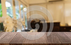 Empty dark wooden table in front of abstract blurred bokeh background of restaurant . can be used for display or montage your