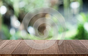 Empty dark wooden table in front of abstract blurred bokeh background of restaurant . can be used for display or montage your.