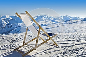 Empty deckchair on the side of a ski slope