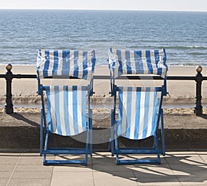 Empty deckchairs looking over the sea