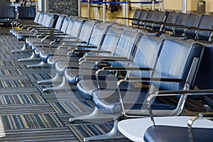 Empty airport departure lounge terminal waiting area with chairs