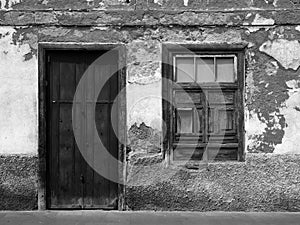 Empty derelict small house with decaying bricks and walls