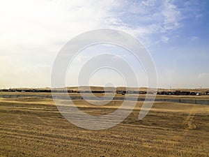 Empty desert area in Sealine, Qatar showing empty road with no people and sand dunes only.