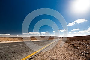 Empty desert road with blue sky.