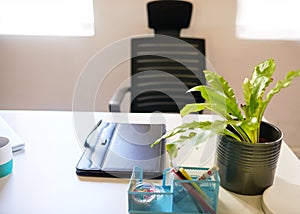 An empty desk in an executive's office with neat organised workspace