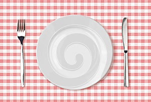 Empty dinner plate top view on pink picnic tablecloth