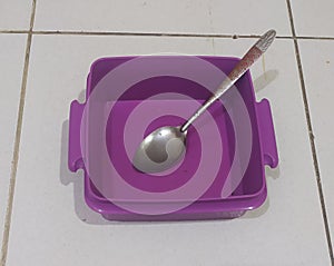 Empty dinning plate and spoon iside