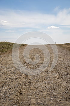 Empty Dirt Road under Clear Blue Sky