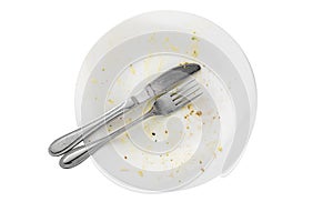 Empty dirty food plate with knife and fork isolated