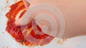 Empty dirty plates with the remains of ketchup. Men`s hands paint a heart on the remains of ketchup. 4k, slow-motion