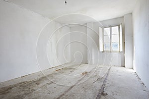 Empty, dirty room in old house, white walls