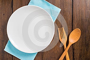 Empty dish, Wooden spoon and fork on wooden background