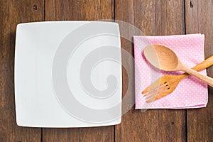 Empty dish, Wooden spoon and fork on wooden background