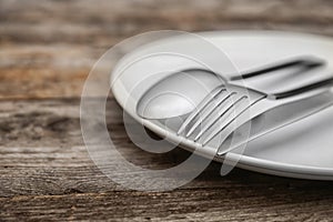 Empty dishware and cutlery on wooden table