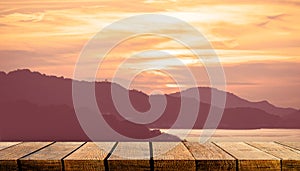 Empty wooden board shelf counter with copy space for advertising backdrop and background with orange sunset island sky photo