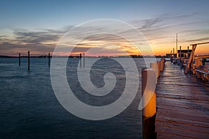 Empty Dock Extending into a Harbor at Sunset