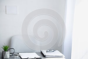 Empty doctor workplace, hospital office on light background, doctor desk