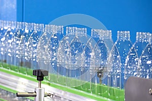 The empty drinking water bottles  on the conveyor belt for filling process